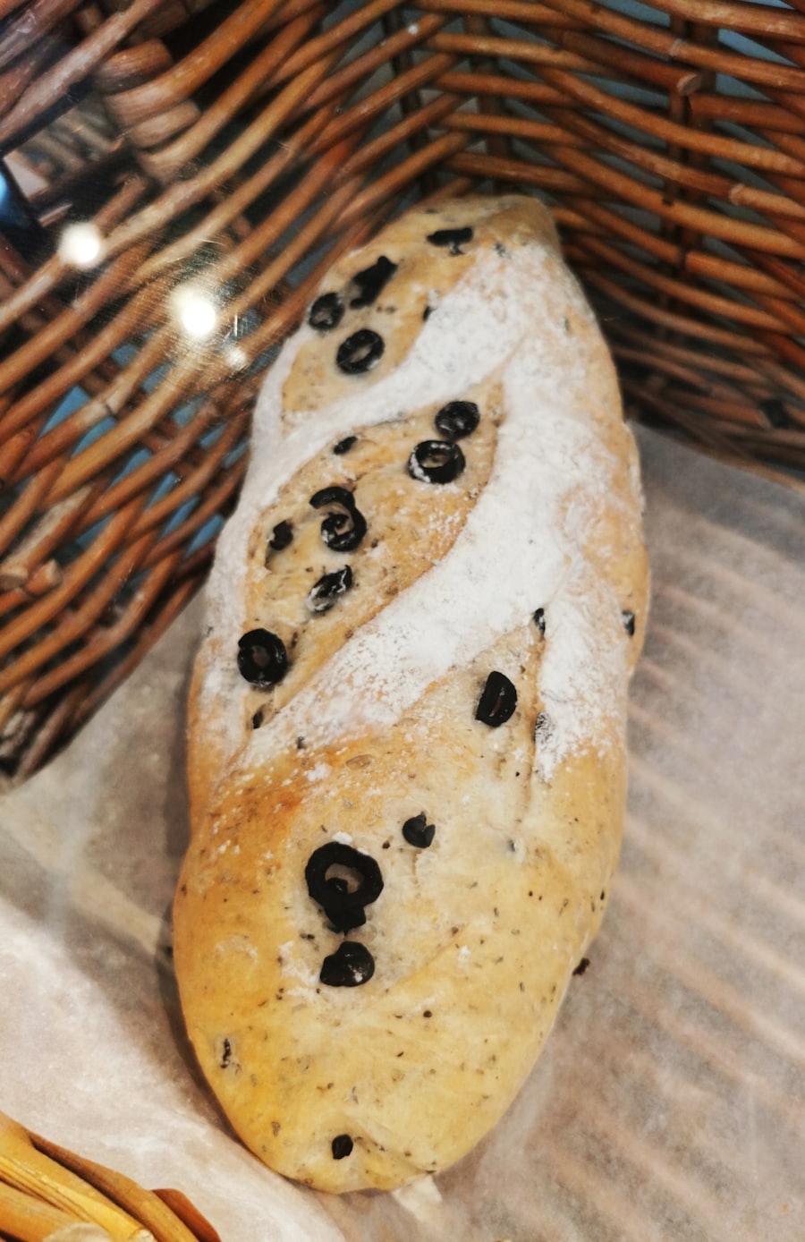 Floured loaf studded with black olives